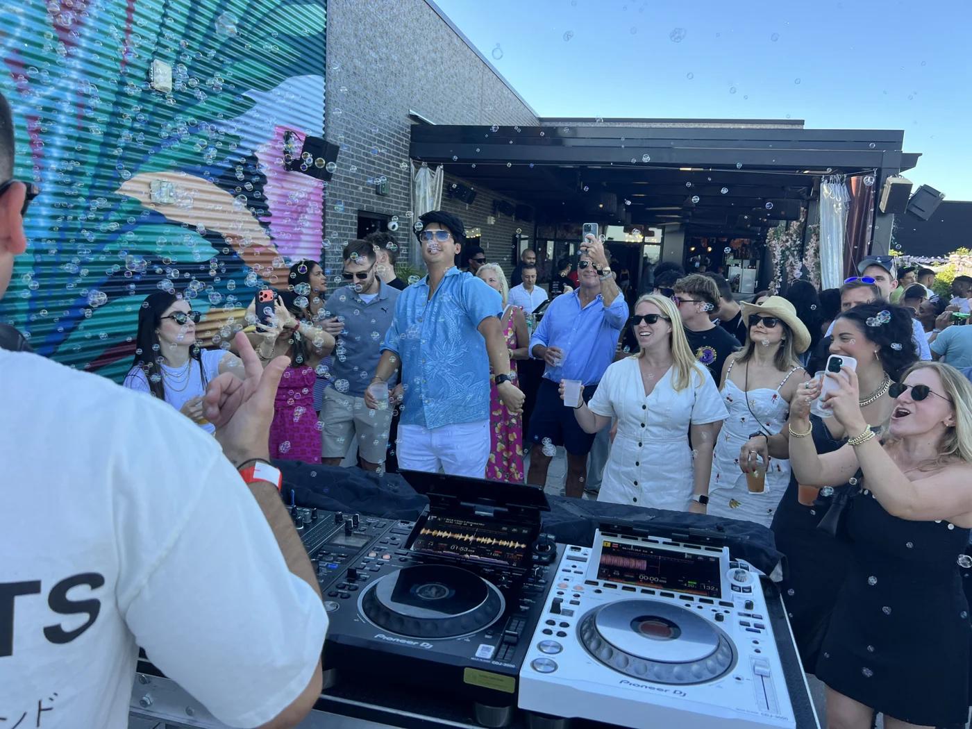 The rooftop crowd dancing in front of Andrew Weiss's DJ booth